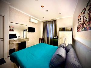 a bedroom with a blue bed and a couch at Heritage Hostel Cairo in Cairo