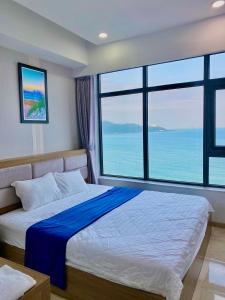 a bedroom with a bed with a large window at Ocean Dream Apartment Nha Trang in Nha Trang