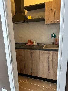 a kitchen with wooden cabinets and a sink at Antico Borgo in Tarsia