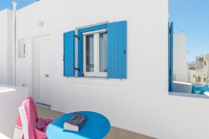 a room with a blue table and a window at Livanios Studios in Adamantas