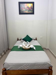 a bedroom with a bed with a towel on it at Hospedaje Humazapa in Tarapoto