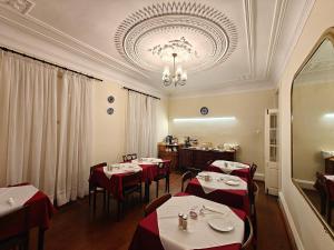 a restaurant with tables with red and white tablecloths at Mirasol Guesthouse in Funchal