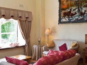 a living room with a couch and a window at Cornucopia in Portree