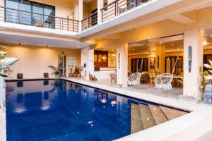 a house with a swimming pool and a patio at Infinity Bay Suites in Puerto Galera