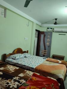 a bedroom with two beds and a wall at Haramani Guest House in Konārka