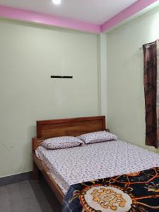 a bedroom with a bed in a room at Haramani Guest House in Konārka