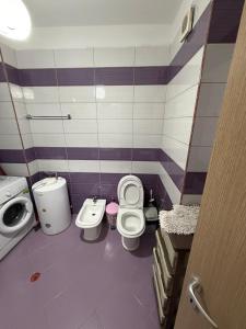 a bathroom with two toilets and a sink at Aldi APARTMENTS in Lezhë