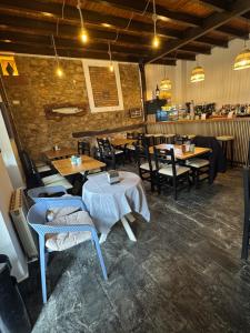 a restaurant with tables and chairs and a bar at Hotel Cuevas Del Mar in Nueva de Llanes