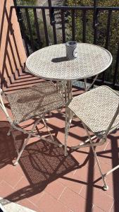 a table and chairs on a patio with a cup on it at Fabio Filzi 32 sub 7 in Lainate