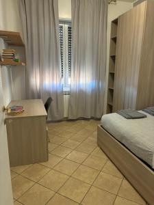 a bedroom with a bed and a desk and a window at Fabio Filzi 32 sub 7 in Lainate