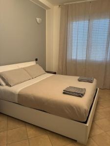 a bedroom with a bed with towels on it at Fabio Filzi 32 sub 7 in Lainate +2 photos
