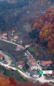 an aerial view of a house in a forest at Apartman Smilic Lukovska banja in Lukovo +6 photos
