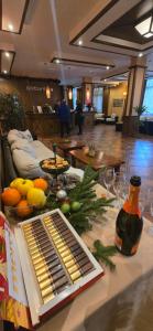 a living room with a table with food and alcohol at Evelina Palace Hotel in Bansko +102 photos