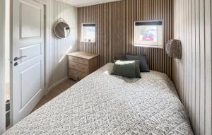 a small bedroom with a bed and a mirror at 3 Bedroom Cozy Home In Haderslev in Haderslev