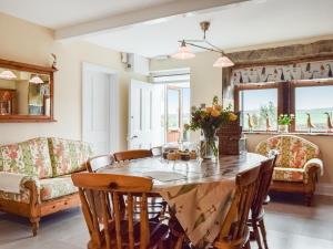 a dining room with a table and chairs at Shelduck Cottage in Holmfirth