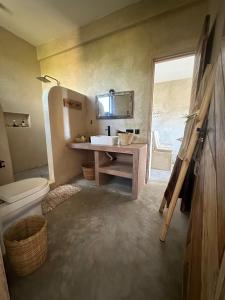 a bathroom with a sink and a toilet at Uroa Sunset Bliss in Uroa +83 photos