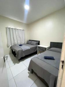 a bedroom with two beds and a window at DUNAS RESIDENCE CASA 14 in Santo Amaro +72 photos