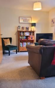 a living room with a couch and a book shelf at 1 Merchants Gate - 2 bedroom, city apartment with private parking in York