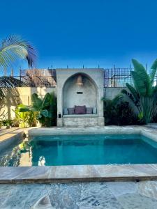a swimming pool in the backyard of a house at Uroa Sunset Bliss in Uroa