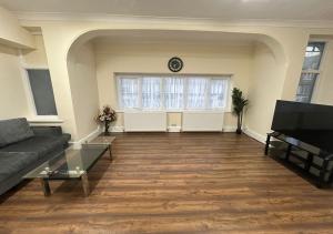 a living room with a couch and a window at SS Sunrise & Silk in Bognor Regis