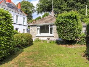 a white house with a window in the yard at Brynhafod in Llanfihangel-geneuʼr-glyn
