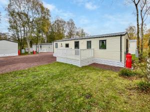 a large white mobile home with a yard at Eskside Lodge in Brechin