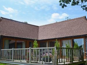 a house with a fence in front of it at The Old Packhouse in Steyning +1 photo