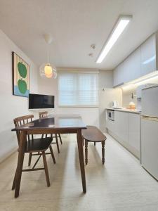 a kitchen with a wooden table and chairs in a room at Check in Seoul in Hongdae 2 in Seoul