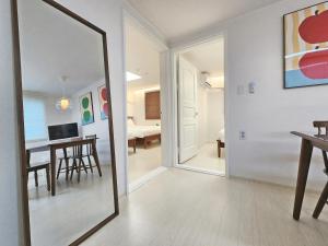 a mirror in a living room with a dining room at Check in Seoul in Hongdae 2 in Seoul