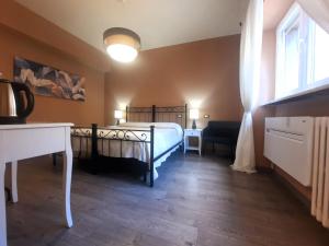 a bedroom with a bed and a desk and a window at Madame Pucci in Lucca