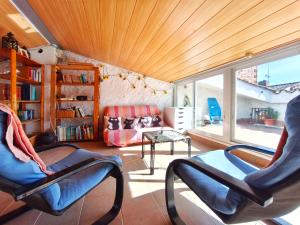 a living room with two chairs and a table at Amplia Casa en Vinaixa, calle Mayor, Cal Mitger in Viñaixa