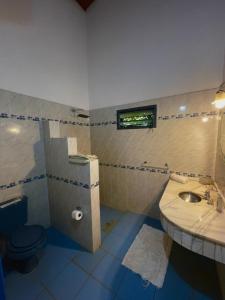 a bathroom with a sink and a toilet at Casa de Campo Las Marías in Areguá +41 photos