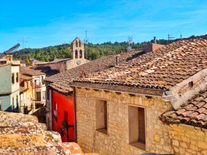 a view of roofs of buildings with a church at Amplia Casa en Vinaixa, calle Mayor, Cal Mitger in Viñaixa