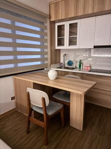a kitchen with a wooden table and two chairs at Maison du nook in Hanoi