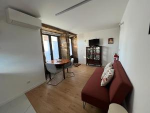 a living room with a couch and a table at Casa das Romãs in Torre de Moncorvo