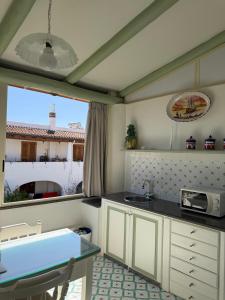 a kitchen with a counter and a sink and a window at Hotel Residence Mendolita in Lipari +54 photos