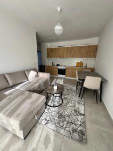 a living room with a couch and a table at Eki Apartments in Sarandë