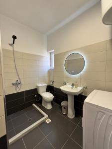 a bathroom with a toilet and a sink at Eki Apartments in Sarandë +40 photos