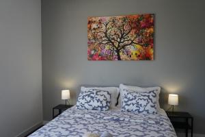 a bedroom with a bed with a painting on the wall at Sea Breeze Apartment in Lagos