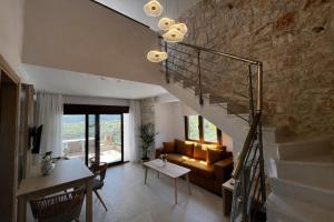 a living room with a staircase and a couch at Aria Vista Chalkidiki in Agios Nikolaos