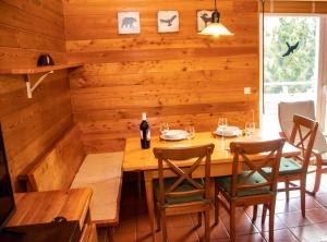 a wooden dining room with a table and chairs at miki Chalets in Pack +15 photos