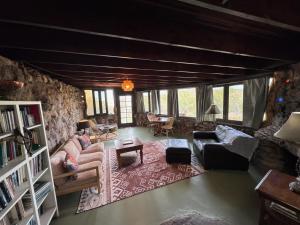 a living room with a stone wall at Tucson Mountain Guest Ranch in Tucson