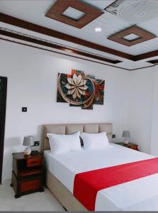 a bedroom with a white bed with a red blanket at Hotel Kandy road in Meda-Ela