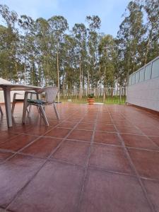 a picnic table and a bench on a patio at Nido Ría in Villaviciosa
