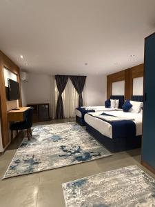 a hotel room with two beds and a desk at The Grand Delta Hotel in Cairo +120 photos