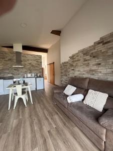 a living room with a couch and a table at El niu del volcà in Olot +23 photos