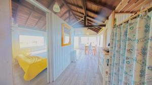 a tiny house with a yellow couch in a room at Casa dos Flamingos in Murtosa