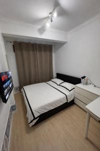 a bedroom with a bed and a tv in it at Double Room near Sintra & Lisbon in Queluz