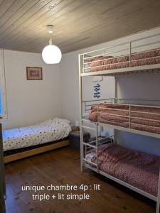 a room with two bunk beds and a lamp at Spacieux apt avec terrasse proche plage in Criel-sur-Mer