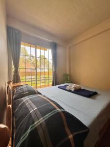 a bedroom with a bed and a window with a view at VidHuset Homestay Sagada in Sagada